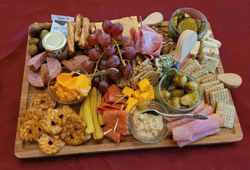 Charcuterie Board full of crackers, cheese, meats, pickled vege