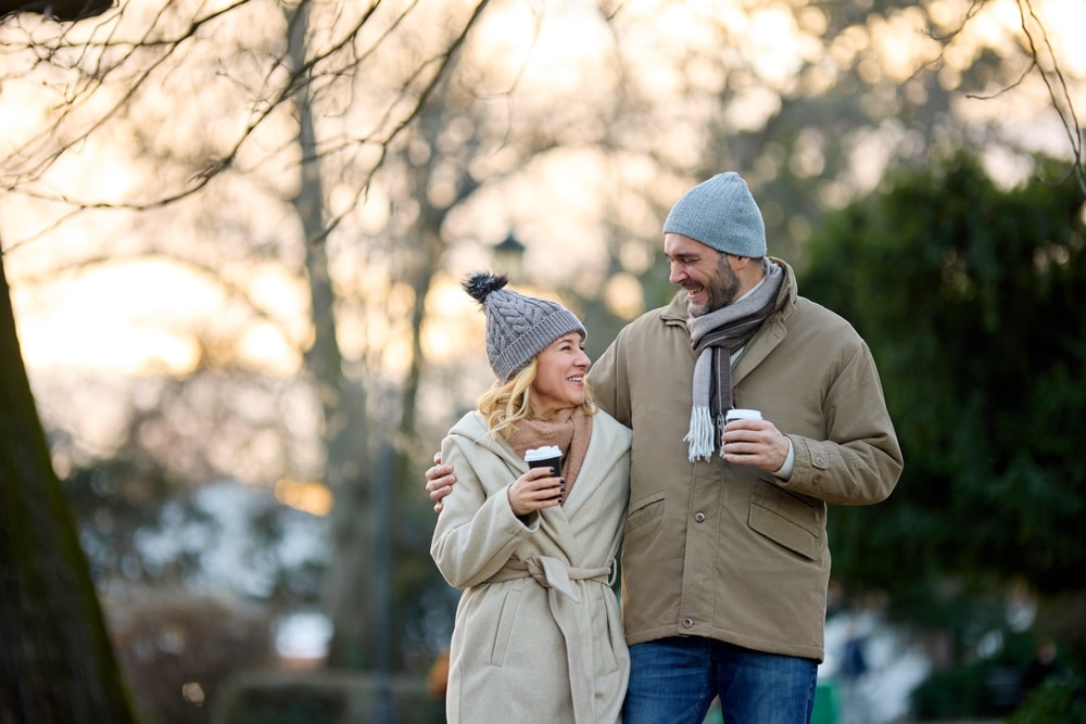 A couple walking outside with coffee during their romantic getaways in Kentucky