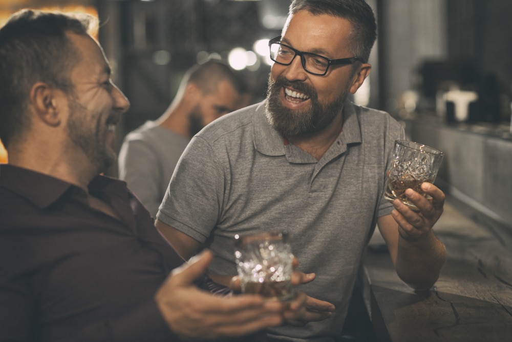 Two Men enjoying drinks at more bourbon distilleries in Kentucky after enjoying makers mark tours