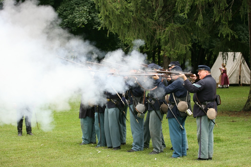 Soliders raising and firing guns during a civil War reenactment at Perryville Battlefield.